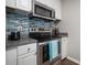 Modern kitchen with stainless steel appliances and stylish backsplash at 800 S Dakota Ave # 221, Tampa, FL 33606