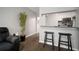 Inviting living space features a modern kitchen view and stylish bar seating with hard wood floors at 800 S Dakota Ave # 221, Tampa, FL 33606