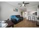 Open-concept living space with hardwood floors, a ceiling fan and an view to the modern kitchen at 800 S Dakota Ave # 221, Tampa, FL 33606