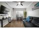 Relaxing living room featuring hardwood floors, large window, ceiling fan and modern decor at 800 S Dakota Ave # 221, Tampa, FL 33606