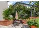 Outdoor seating area featuring lush landscaping and providing shade at 800 S Dakota Ave # 221, Tampa, FL 33606