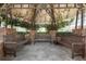 Outdoor covered seating area featuring benches, landscaping and providing shade at 800 S Dakota Ave # 221, Tampa, FL 33606