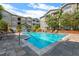 Community pool with lounge chairs and shade at 800 S Dakota Ave # 221, Tampa, FL 33606