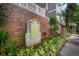 Attractive Hyde Park Walk condominium signage amid lush greenery and brickwork at 800 S Dakota Ave # 221, Tampa, FL 33606