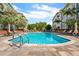 Enjoy this beautifully landscaped outdoor swimming pool surrounded by lounge chairs and lush greenery at 800 S Dakota Ave # 221, Tampa, FL 33606