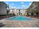 Enjoy this beautifully landscaped outdoor swimming pool surrounded by lounge chairs and lush greenery at 800 S Dakota Ave # 221, Tampa, FL 33606