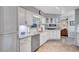 Bright kitchen with marble countertops, stainless steel appliances, and a view into adjacent living room at 8243 37Th N Ave, St Petersburg, FL 33710