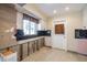 Bright kitchen with white cabinetry, black backsplash, and a window offering natural light at 88 45Th Ave, St Pete Beach, FL 33706