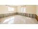 Spacious room featuring natural sunlight, multiple windows, and speckled floors at 88 45Th Ave, St Pete Beach, FL 33706