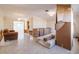 Spacious living room featuring a charming chandelier, and plenty of natural light coming through the large windows at 88 45Th Ave, St Pete Beach, FL 33706