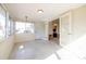 Bright sun room featuring natural sunlight, multiple windows, and speckled floors at 88 45Th Ave, St Pete Beach, FL 33706
