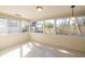 Sun-filled room featuring bright sunlight, multiple windows, and speckled floors at 88 45Th Ave, St Pete Beach, FL 33706