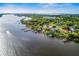 Stunning aerial view of waterfront homes with private docks and lush green landscaping on a sunny day at 8910 Eagle Watch Dr, Riverview, FL 33578