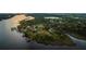 Scenic aerial view of waterfront properties featuring private docks, lush trees, and serene river views at 8910 Eagle Watch Dr, Riverview, FL 33578