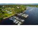 Aerial view of waterfront homes, boat docks, and community pool, showcasing the neighborhood's amenities at 8910 Eagle Watch Dr, Riverview, FL 33578