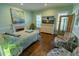 Bedroom features hardwood floors, windows with blinds, sitting area and pastel color walls at 8910 Eagle Watch Dr, Riverview, FL 33578