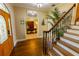 Inviting foyer with hardwood floors, staircase, and view into the home office at 8910 Eagle Watch Dr, Riverview, FL 33578