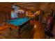 Rustic game room features a pool table, wooden walls, and built in bar area at 8910 Eagle Watch Dr, Riverview, FL 33578