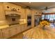 A full view of the kitchen featuring stainless steel appliances, granite counters, tile backsplash and cream cabinets at 8910 Eagle Watch Dr, Riverview, FL 33578