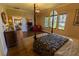 Lovely bedroom with decorative four-poster bed, sitting area, hardwood floors and many windows at 8910 Eagle Watch Dr, Riverview, FL 33578