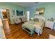 Inviting main bedroom with hardwood floors, seating area, and light-blue walls at 8910 Eagle Watch Dr, Riverview, FL 33578