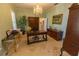 Elegant home office with classic desk, chandelier, and built-in cabinets at 8910 Eagle Watch Dr, Riverview, FL 33578