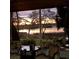 Peaceful view of the lake through a sunroom window, with cozy seating and natural light at 8910 Eagle Watch Dr, Riverview, FL 33578