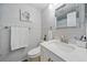 Bright bathroom featuring light gray tiling, modern vanity, and decorative accents at 9122 Suffield Ct, Tampa, FL 33615