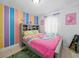 Colorful bedroom with bright decor and carpet flooring, creating a cheerful atmosphere at 9122 Suffield Ct, Tampa, FL 33615
