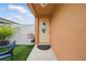 Inviting front entrance with a charming decorative glass door and well-manicured artificial turf at 9122 Suffield Ct, Tampa, FL 33615
