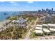 Stunning aerial view of a coastal community with palm trees, pools, city skyline and waterfront access at 920 N Shore Ne Dr, St Petersburg, FL 33701