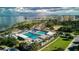 Stunning aerial view showcases the community pool, lush greenery, and waterfront access with amazing views at 920 N Shore Ne Dr, St Petersburg, FL 33701