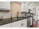 Modern kitchen featuring white cabinets, black hardware, and stainless steel appliances at 920 N Shore Ne Dr, St Petersburg, FL 33701