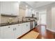 Modern kitchen featuring white cabinets, black hardware, and stainless steel appliances at 920 N Shore Ne Dr, St Petersburg, FL 33701