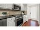 Modern kitchen featuring white cabinets, black hardware, and stainless steel appliances at 920 N Shore Ne Dr, St Petersburg, FL 33701