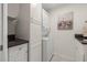 Convenient laundry closet with stacked washer and dryer, plus extra cabinet space at 920 N Shore Ne Dr, St Petersburg, FL 33701