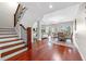 Bright living area features hardwood floors, elegant staircase, and dining area with beach views at 920 N Shore Ne Dr, St Petersburg, FL 33701