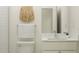 Well-lit bathroom with white vanity, modern fixtures, toilet, and decor at 9308 Gladsome Dr, Land O Lakes, FL 34637