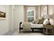Relaxing bedroom featuring a daybed with pillows, natural light, and a decorative side table with lamp at 9314 Gladsome Dr, Land O Lakes, FL 34637