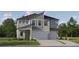 Charming new two-story home with attached two-car garage, landscaped yard, and modern architectural details at 9314 Gladsome Dr, Land O Lakes, FL 34637