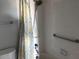 Bright bathroom with yellow and gray shower curtain at 9860 62Nd N Ter # 1036, St Petersburg, FL 33708
