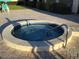Inviting hot tub featuring a tiled exterior and a convenient handrail for easy access at 9860 62Nd N Ter # 1036, St Petersburg, FL 33708