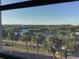 Serene lake view showcasing tranquil waters and lush palm trees seen through the window at 9860 62Nd N Ter # 1036, St Petersburg, FL 33708