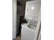 Laundry room with a stacked washer and dryer and shelves for storage at 9860 62Nd N Ter # 1036, St Petersburg, FL 33708