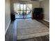 Comfortable living room with a large rug, TV, and sliding glass doors to a balcony at 9860 62Nd N Ter # 1036, St Petersburg, FL 33708