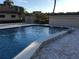 Community pool with a patio at 9860 62Nd N Ter # 1036, St Petersburg, FL 33708