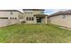 Manicured backyard with a grass lawn, fence, and covered patio space at 9917 Ivory Dr, Ruskin, FL 33573