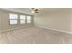 Large, carpeted bedroom with bright windows providing natural light at 9917 Ivory Dr, Ruskin, FL 33573