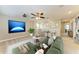 Upstairs bonus room featuring a large screen, comfortable seating, and stylish decor at 9917 Ivory Dr, Ruskin, FL 33573