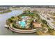 Aerial view of a community with a sparkling pool, tennis courts, and lush landscaping at 9917 Ivory Dr, Ruskin, FL 33573